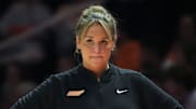 Tennessee women's basketball coach Kim Caldwell stands on the sidelines during a game.