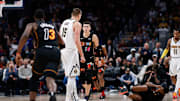 Nov 8, 2021; Denver, Colorado, USA; Miami Heat forward Markieff Morris (8) lies on the ground after a play with Denver Nuggets center Nikola Jokic (15) as guard Tyler Herro (14) and center Bam Adebayo (13) react in the fourth quarter at Ball Arena. Mandatory Credit: Isaiah J. Downing-Imagn Images