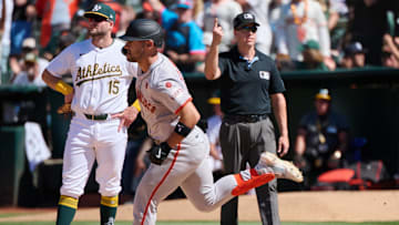 Aug 18, 2024; Oakland, California, USA; Oakland Athletics outfielder Seth Brown (15) reacts as San Francisco Giants outfielder Michael Conforto (8) runs the bases after hitting a one-run home run and first base umpire Chris Segal (96) calls the play during the tenth inning at Oakland-Alameda County Coliseum.