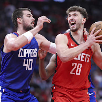 Mar 6, 2024; Houston, Texas, USA; Houston Rockets center Alperen Sengun (28) controls the ball as Los Angeles Clippers center Ivica Zubac (40) defends during the second quarter at Toyota Center. Mandatory Credit: Troy Taormina-Imagn Images