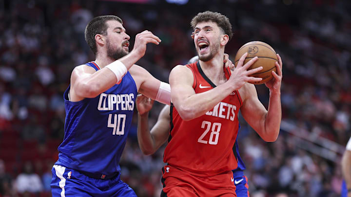 Mar 6, 2024; Houston, Texas, USA; Houston Rockets center Alperen Sengun (28) controls the ball as Los Angeles Clippers center Ivica Zubac (40) defends during the second quarter at Toyota Center. Mandatory Credit: Troy Taormina-Imagn Images