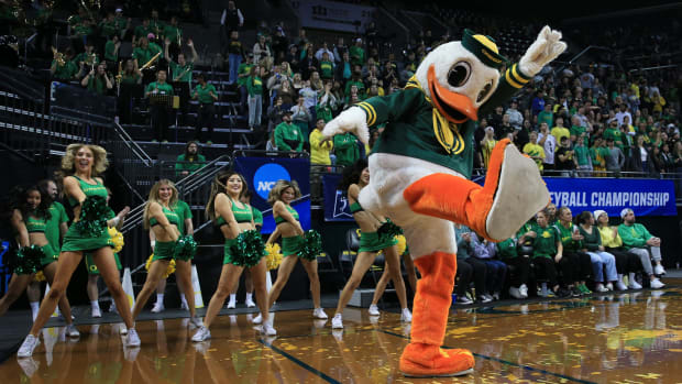 The Duck dances with cheerleaders during Oregon's match against Arkansas in their NCAA Round 2 match in Eugene.