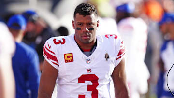 Oct 19, 2025; Denver, Colorado, USA; New York Giants quarterback Russell Wilson (3) looks on from the sidelines during the second half against the Denver Broncos at Empower Field at Mile High. Mandatory Credit: Ron Chenoy-Imagn Images