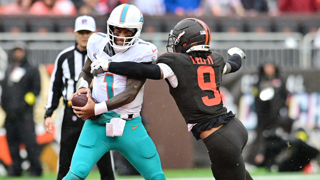 Oct 19, 2025; Cleveland, Ohio, USA; Cleveland Browns safety Grant Delpit (9) sacks Miami Dolphins quarterback Tua Tagovailoa (1) during the first half at Huntington Bank Field. Mandatory Credit: Ken Blaze-Imagn Images