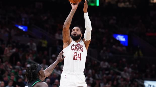 Marcus Morris Sr. shoots against Boston Celtics guard Jrue Holiday.