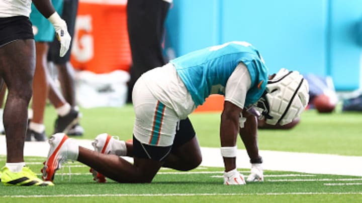 Miami Dolphins cornerback Artie Burns kneels on the ground after suffering an injury at practice.