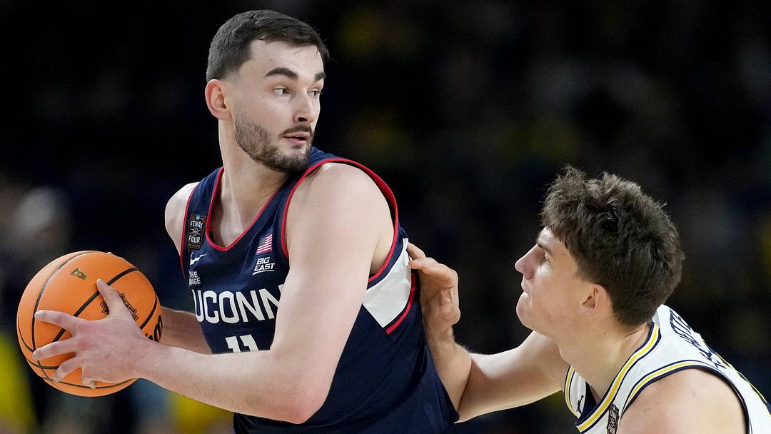 UConn Huskies forward Alex Karaban (11) is defended by Michigan Wolverines forward Will Tschetter (42) on Monday, April 6, 2026, during the NCAA men’s basketball national championship game at Lucas Oil Stadium in Indianapolis. UConn Huskies forward Alex Karaban (11) is defended by Michigan Wolverines forward Will Tschetter (42) on Monday, April 6, 2026, during the NCAA men’s basketball national championship game at Lucas Oil Stadium in Indianapolis.