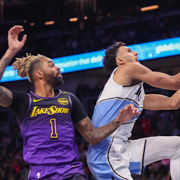 Dec 6, 2024; Atlanta, Georgia, USA; Atlanta Hawks forward Zaccharie Risacher (10) shoots past Los Angeles Lakers guard D'Angelo Russell (1) and forward LeBron James (23) in the fourth quarter at State Farm Arena. Mandatory Credit: Brett Davis-Imagn Images
