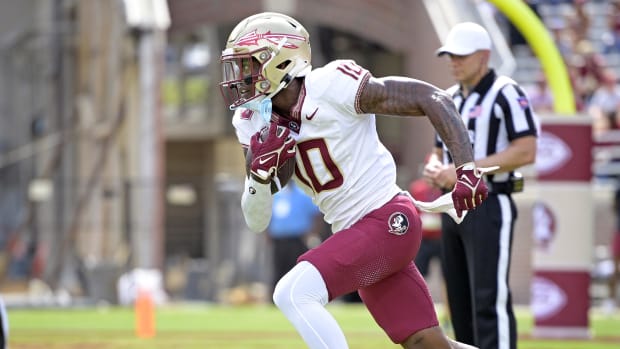 Florida State Seminoles wide receiver Malik Benson runs out of the end zone during a college football game in the ACC.
