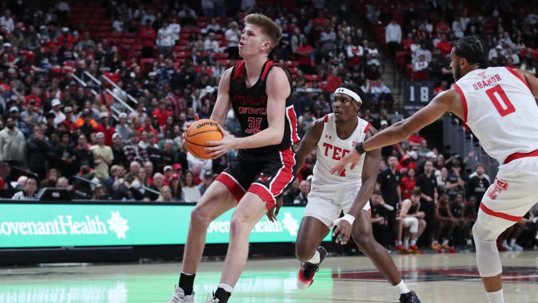 Dec 13, 2022; Lubbock, Texas, USA; Eastern Washington Eagles forward Dane Erikstrup (32) stops to shoot in front of Texas Tech Red Raiders forward Robert Jennings (4) and forward Kevin Obanor (0) in the fist half at United Supermarkets Arena. Mandatory Credit: Michael C. Johnson-USA TODAY Sports