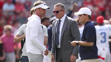 Oct 18, 2025; Athens, Georgia, USA; Mississippi Rebels head coach Lane Kiffin talks with sports commentator Kirk Herbstreit prior to the game against the Georgia Bulldogs at Sanford Stadium. Mandatory Credit: Brett Davis-Imagn Images