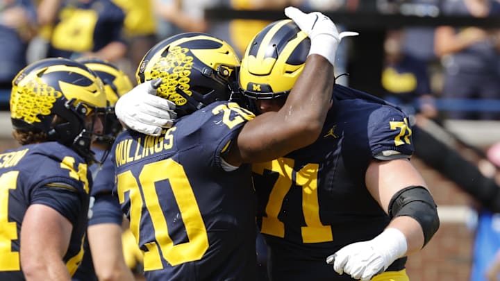 Sep 14, 2024; Ann Arbor, Michigan, USA;  Michigan Wolverines running back Kalel Mullings (20) celebrates with offensive lineman Evan Link (71) after running for a touchdown against the Arkansas State Red Wolves in first half at Michigan Stadium.