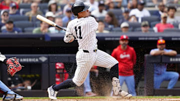 Aug 31, 2024; Bronx, New York, USA; New York Yankees shortstop Anthony Volpe (11) hits an RBI infield single against the St. Louis Cardinals during the eighth inning at Yankee Stadium. Mandatory Credit: Gregory Fisher-USA TODAY Sports