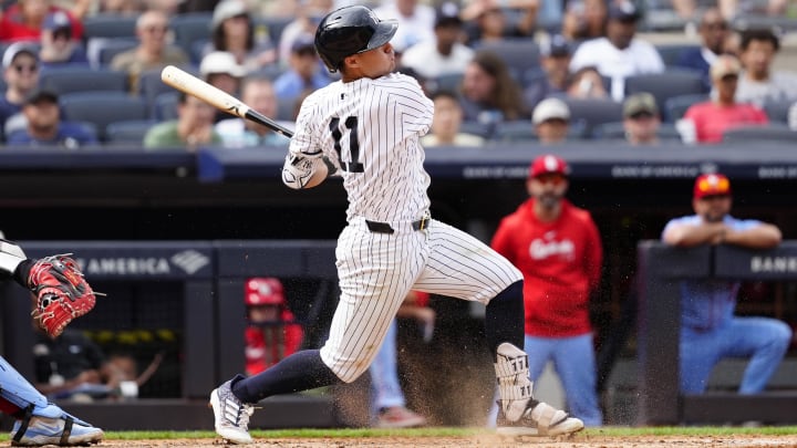 Aug 31, 2024; Bronx, New York, USA; New York Yankees shortstop Anthony Volpe (11) hits an RBI infield single against the St. Louis Cardinals during the eighth inning at Yankee Stadium. Mandatory Credit: Gregory Fisher-USA TODAY Sports