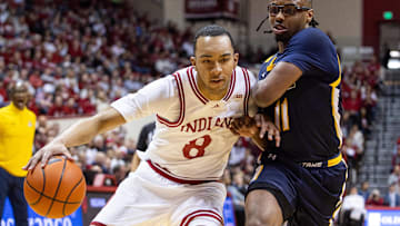 Indiana Hoosiers forward Bryson Tucker (8) dribbles the ball while UNC-Greensboro Spartans guard Ronald Polite III (11) defends in the first half at Simon Skjodt Assembly Hall.