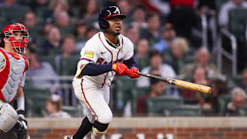 Apr 8, 2025; Atlanta, Georgia, USA; Atlanta Braves second baseman Ozzie Albies (1) hits a double against the Philadelphia Phillies in the third inning at Truist Park. Mandatory Credit: Brett Davis-Imagn Images