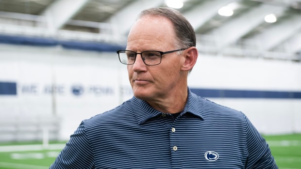 Penn State defensive coordinator Tom Allen turns his head to his right as he listens to a reporter's question.