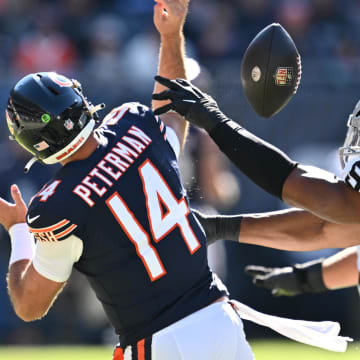 Oct 22, 2023; Chicago, Illinois, USA;  Chicago Bears quarterback Nathan Peterman (14) has the ball stripped away by Las Vegas Raiders defensive end Tyree Wilson (9) in the second quarter at Soldier Field. Mandatory Credit: Jamie Sabau-USA TODAY Sports