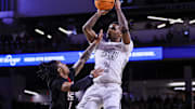 Jan 21, 2025; Cincinnati, Ohio, USA; Cincinnati Bearcats guard Jizzle James (2) shoots against Texas Tech Red Raiders guard Elijah Hawkins (3) in the first half at Fifth Third Arena. Mandatory Credit: Katie Stratman-Imagn Images