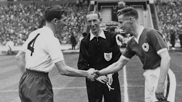 Jimmy Walsh shakes hands with Danny Blanchflower, the Spurs captain, before the start of the 1961 FA Cup Final.