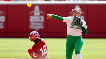 Oregon's Katie Flannery (6) attempts to turn a double play as Oklahoma's Maya Bland (12) slides into second in the seventh inning of the NCAA Norman Regional tournament softball final between the Oklahoma Sooners and the Oregon Ducks.