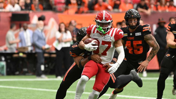Jun 15, 2024; Vancouver, British Columbia, CAN; during the first half Calgary Stampeders wide receiver Erik Brooks (87) runs with the ball against BC Lions defensive lineman Sione Teuhema (0) at BC Place. Mandatory Credit: Simon Fearn-USA TODAY Sports
