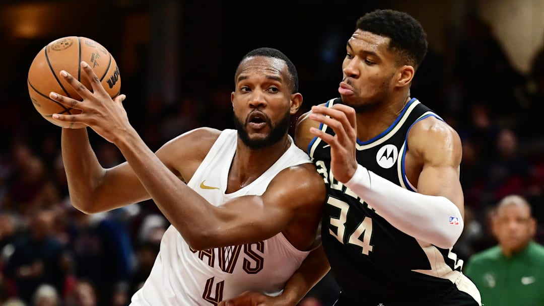Dec 20, 2024; Cleveland, Ohio, USA; Cleveland Cavaliers forward Evan Mobley (4) drives to the basket against Milwaukee Bucks forward Giannis Antetokounmpo (34) during the second half at Rocket Mortgage FieldHouse. Mandatory Credit: Ken Blaze-Imagn Images