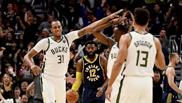 Milwaukee Bucks forward John Henson (31) high fives guard Tony Snell (21) after scoring a three point basket against the Indiana Pacers during a 2018 regular season game at Fiserv Forum. 