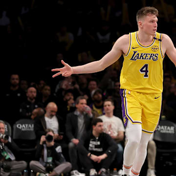 Mar 10, 2025; Brooklyn, New York, USA; Los Angeles Lakers guard Dalton Knecht (4) celebrates his three point shot against the Brooklyn Nets during the third quarter at Barclays Center. Mandatory Credit: Brad Penner-Imagn Images
