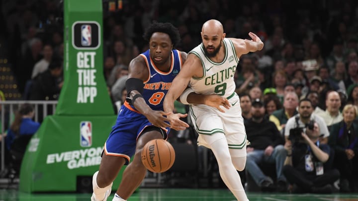 Apr 11, 2024; Boston, Massachusetts, USA;  New York Knicks forward OG Anunoby (8) and Boston Celtics guard Derrick White (9) battle for a loose ball during the first half at TD Garden. Mandatory Credit: Bob DeChiara-USA TODAY Sports