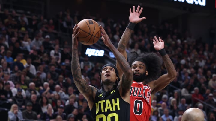 Mar 6, 2024; Salt Lake City, Utah, USA; Utah Jazz guard Jordan Clarkson (00) goes to the basket past Chicago Bulls guard Coby White (0) during the second quarter at Delta Center. Mandatory Credit: Rob Gray-USA TODAY Sports