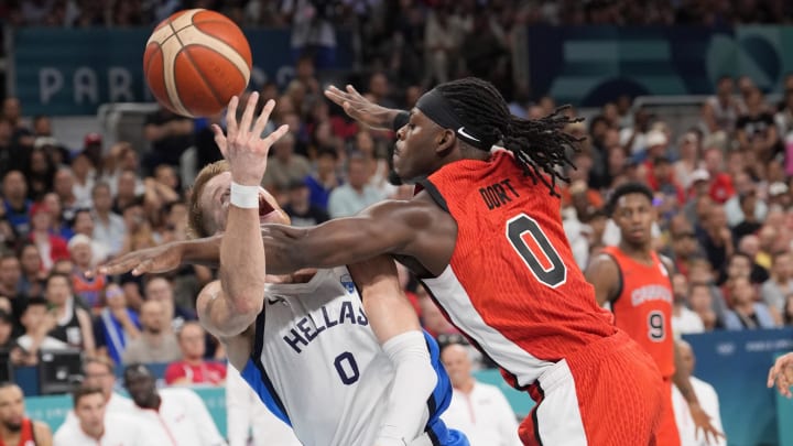 Jul 27, 2024; Villeneuve-d'Ascq, France; Canada guard Luguentz Dort (0) defends against Greece point guard Thomas Walkup (0) in the second half during the Paris 2024 Olympic Summer Games at Stade Pierre-Mauroy. Mandatory Credit: John David Mercer-USA TODAY Sports