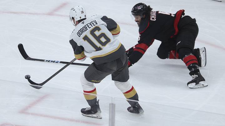 Jun 2, 2026; Raleigh, North Carolina, USA; Carolina Hurricanes defenseman Jalen Chatfield (5) reaches for the puck a- Vegas Golden Knights right wing Pavel Dorofeyev (16) during the first period in game one of the 2026 Stanley Cup Final at Lenovo Center. 