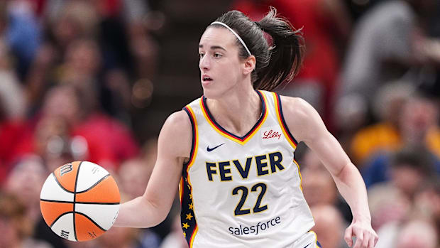 Indiana Fever guard Caitlin Clark (22) dribbles the ball up the court during a game against the Phoenix Mercury.