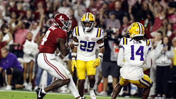 Nov 4, 2023; Tuscaloosa, Alabama, USA; Alabama Crimson Tide quarterback Jalen Milroe (4) carries the ball in for a touchdown against the LSU Tigers during the first half at Bryant-Denny Stadium. Mandatory Credit: Butch Dill-Imagn Images