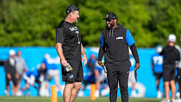 Detroit Lions head coach Dan Campbell talks to defensive coordinator Kelvin Sheppard at practice during training camp at Meijer Performance Center in Allen Park on Tuesday, July 22, 2025.