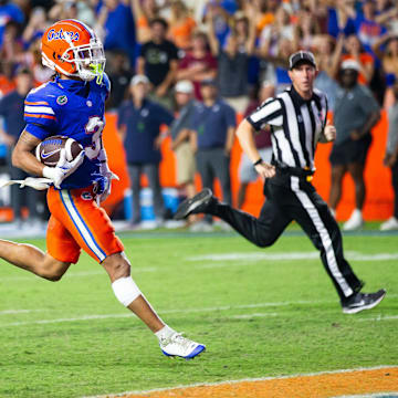 Florida Gators wide receiver Eugene Wilson III (3) runs for a touchdown as he looks back to Samford Bulldogs cornerback Kamron Smith (16) during the second half to make it 38-7 after the extra point at Ben Hill Griffin Stadium in Gainesville, FL on Saturday, September 7, 2024 against the Samford Bulldogs. The Florida Gators won 45-7 over the Bulldogs. [Doug Engle/Gainesville Sun]