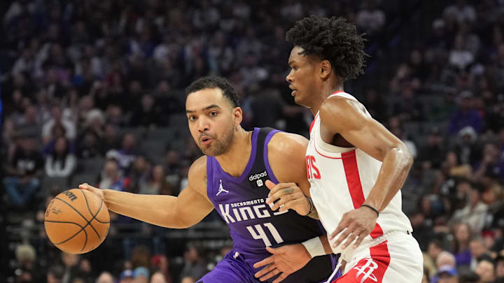 Mar 10, 2024; Sacramento, California, USA; Sacramento Kings forward Trey Lyles (41) dribbles against Houston Rockets forward Amen Thompson (right) during the second quarter at Golden 1 Center. Mandatory Credit: Darren Yamashita-Imagn Images