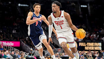 Mar 14, 2025; Kansas City, MO, USA; Texas Tech Red Raiders guard Kevin Overton (1) brings the ball up court around Arizona Wildcats forward Carter Bryant (9) during the first half at T-Mobile Center. Mandatory Credit: William Purnell-Imagn Images
