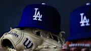 Jul 30, 2025; Cincinnati, Ohio, USA; A general view of a Los Angeles Dodgers hat and glove during the second inning in the game against the Cincinnati Reds at Great American Ball Park. Mandatory Credit: Katie Stratman-Imagn Images