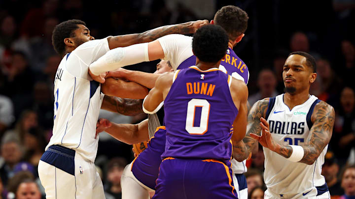 Dallas Mavericks forward Naji Marshall punches Phoenix Suns center Jusuf Nurkic during the third quarter at Footprint Center on December 27, 2024. 