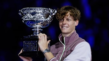 Jannik Sinner holds the trophy at the 2024 Australian Open.