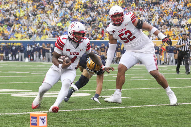 Sep 27, 2025; Morgantown, West Virginia, USA; Utah Utes quarterback Devon Dampier (4) runs the ball for a touchdown during th