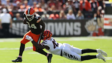 Sep 7, 2025; Cleveland, Ohio, USA; Cleveland Browns running back Jerome Ford (34) is tackled by Cincinnati Bengals linebacker Oren Burks (42) during the second half at Huntington Bank Field. Mandatory Credit: Scott Galvin-Imagn Images