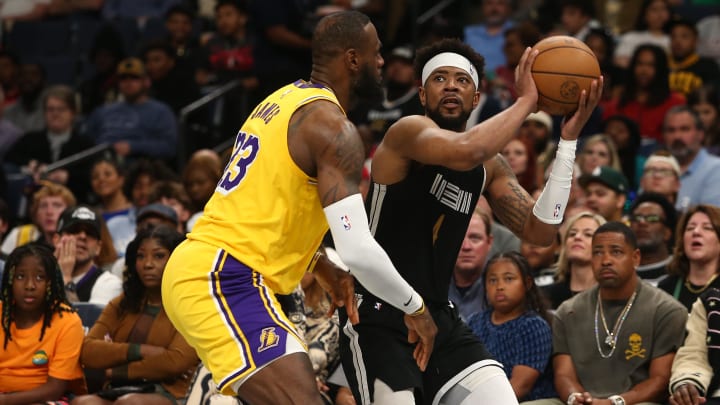 Apr 12, 2024; Memphis, Tennessee, USA; Memphis Grizzlies guard Jordan Goodwin (4) handles the ball as Los Angeles Lakers forward LeBron James (23) defends during the second half at FedExForum. Mandatory Credit: Petre Thomas-USA TODAY Sports