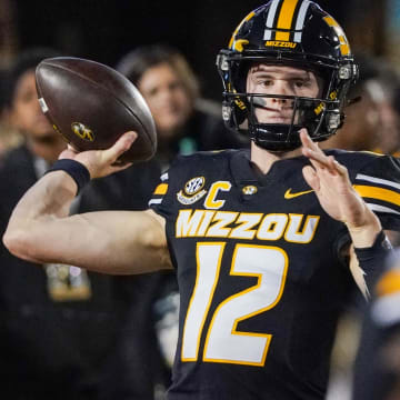 Nov 18, 2023; Columbia, Missouri, USA; Missouri Tigers quarterback Brady Cook (12) warms up against the Florida Gators prior to a game at Faurot Field at Memorial Stadium. Mandatory Credit: Denny Medley-USA TODAY Sports