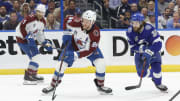 Colorado Avalanche right wing Mikko Rantanen (96) skates with the puck past Tampa Bay Lightning left wing Brandon Hagel during the  2022 Stanley Cup Final at Amalie Arena.