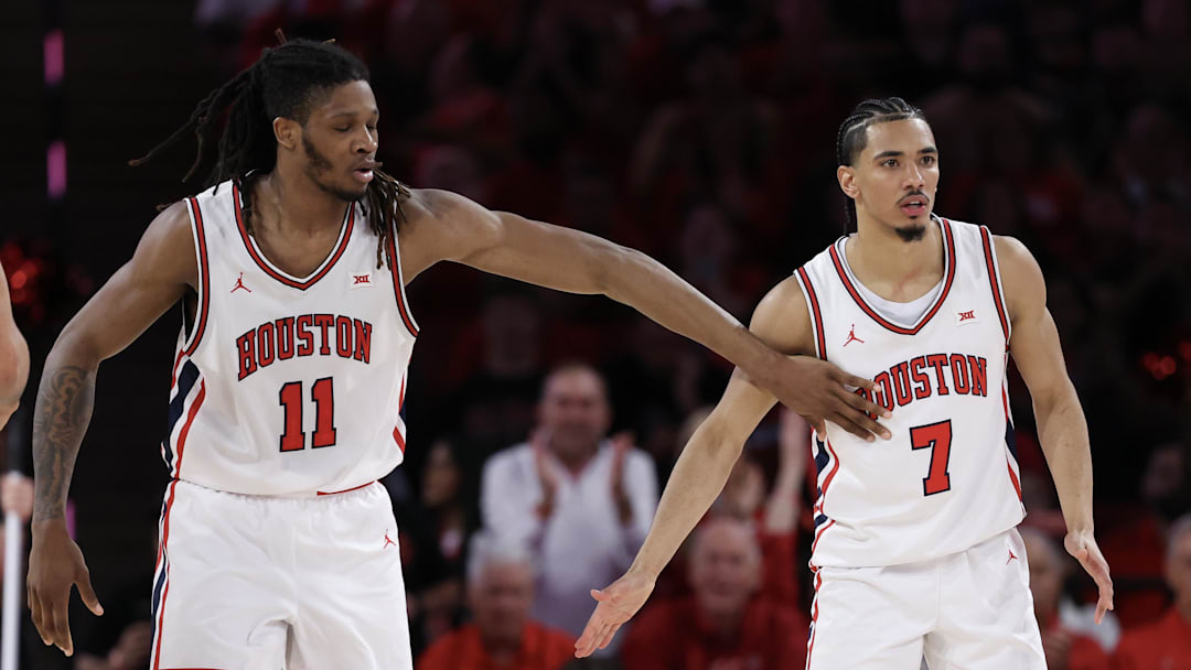 Mar 4, 2026; Houston, Texas, USA;  Houston Cougars forward Joseph Tugler (11) reacts to  guard Milos Uzan (7) play agains the Baylor Bears n the  first half at Fertitta Center. Mandatory Credit: Thomas Shea-Imagn Images