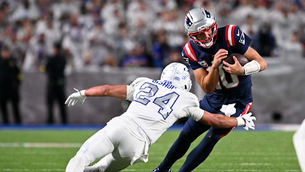 New England Patriots quarterback Drake Maye (10) rushes the ball against Buffalo Bills safety Cole Bishop.
