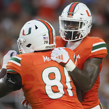 Sep 1, 2023; Miami Gardens, Florida, USA; Miami Hurricanes wide receiver Colbie Young (4) celebrates with offensive lineman Francis Mauigoa (81) after scoring a touchdown against the Miami Redhawks during the first quarter at Hard Rock Stadium. Mandatory Credit: Sam Navarro-Imagn Images